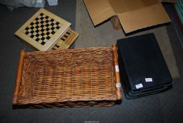 A wooden set of board games, wicker basket, plastic drawers etc.