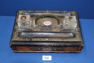 An ebonised double Standish/Inkstand with two glass ink bottles having pink china plaque,