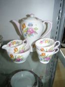 A Shelley part Coffee Set for two, with ground with floral detail, pale pink handles and rims,