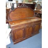 A Victorian Mahogany Sideboard having three frieze drawers and a triple doored cupboard below,