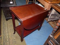 A Mahogany tea Trolley having a lower shelf, the top having drop leaves to convert to a tea table,
