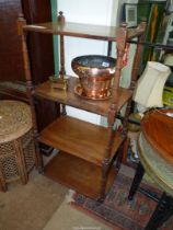 A Mahogany four tier Etagere having turned supports, 19 7/8'' wide x 13 1/2'' deep x 42 1/8'' high.