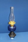 An Oil Lamp with blue glass reservoir, 21 1/2'' overall including chimney.