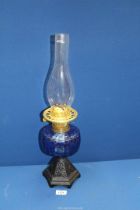 An Oil Lamp with blue glass reservoir, 21 1/2'' overall including chimney.