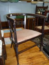 An arts and crafts type bow-back Boxwood strung Mahogany framed Elbow Chair having fretworked and