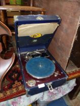 A Triumphon Record Player with records.