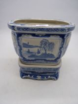 A large blue and white Oriental Planter and stand.