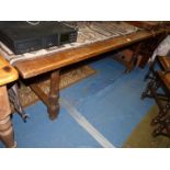 A large Oak Dining Table standing on substantial turned legs united by a "H" stretcher,