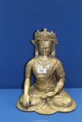 A cast metal Buddhist figure in brass finish, 13" tall.