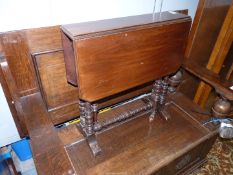 A Mahogany Sutherland Table standing on turned legs,