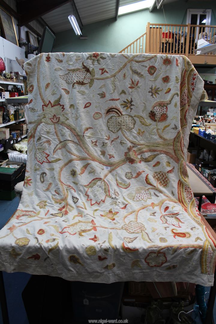 A large piece of crewel work fabric in cream having yellow, orange and pink floral design (a/f),