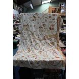 A large piece of crewel work fabric in cream having yellow, orange and pink floral design (a/f),