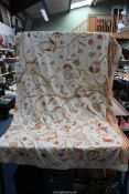 A large piece of crewel work fabric in cream having yellow, orange and pink floral design (a/f),