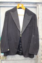 A vintage Black tie dinner jacket having one button fastening and silk lapel facings,