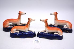 Two pairs of Staffordshire greyhound pen holders, 6'' and 6 1/2'' wide bases.