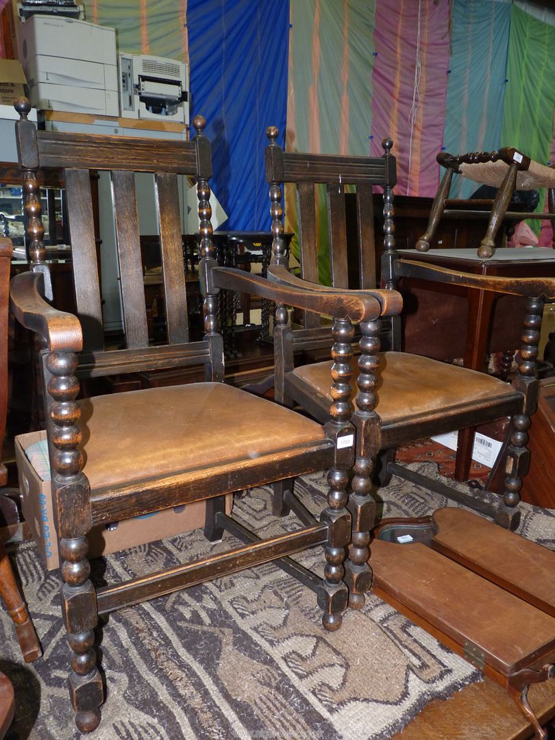 A set of six Oak framed Dining Chairs including a pair of carvers,