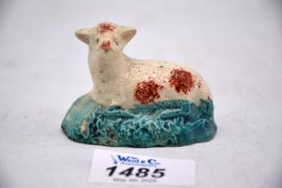 An early Staffordshire figure of a lamb, 2 1/2" x 1 3/4" tall., chipped to base.