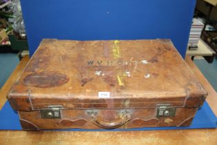 A 1920's leather Suitcase, 28'' wide x 18'' deep x 8'' high.