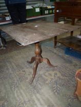 An Oak snap-top Occasional Table, the square top raised on a turned pillar with three splay feet,