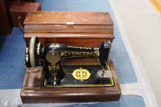 A cased vintage Singer sewing machine.