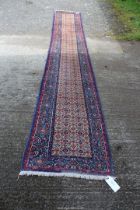 A bordered, patterned and fringed Runner,