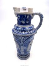 A large 'Westerwald' German stoneware pitcher moulded with figures, 13 1/2" tall.