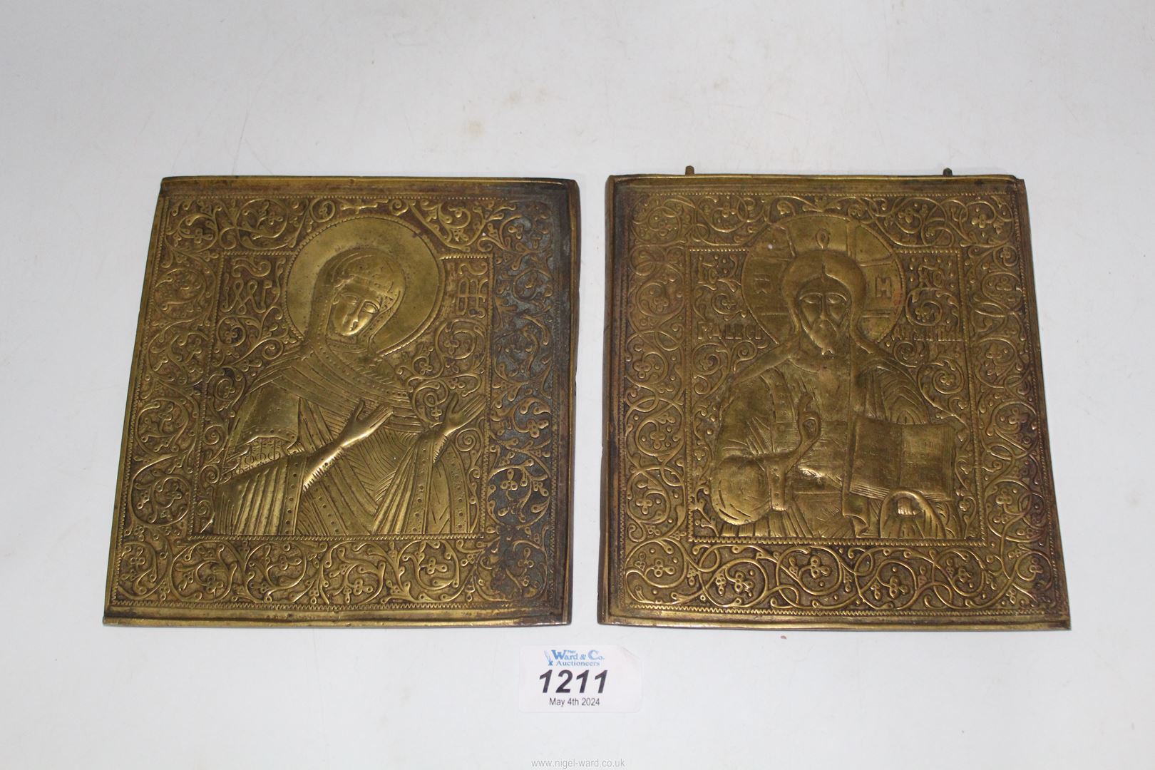 An unusual near pair of cast brass Russian icons, 18th - 19th c.