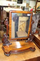 A circa 1900 Mahogany swing Mirror having scroll feature side supports and a shaped base,