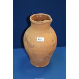 A large terracotta jug (handle missing), 13" tall.