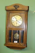 A Hermle Oak cased Wall clock having bevelled glass panels,
