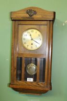 A Hermle Oak cased Wall clock having bevelled glass panels,