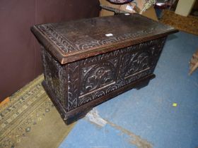 A carved Oak two panelled Blanket Chest, decorated with repeated arch details and foliage,