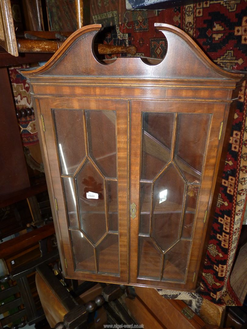 A Mahogany wall hanging corner display cabinet having a pair of opposing seven pane glazed doors