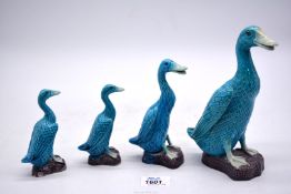 A set of four oriental, graduated sitting Ducks in turquoise glaze, from 4 1/2'' tall to 8'' tall.