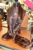 A fur stole with brown lining and fur fold back collar having lined tapered ends.