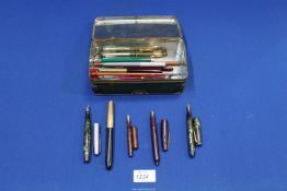 A tin of pens, pencils, etc.