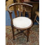 An arts and crafts circular seated bow back Elbow Chair standing on turned legs with turned cross