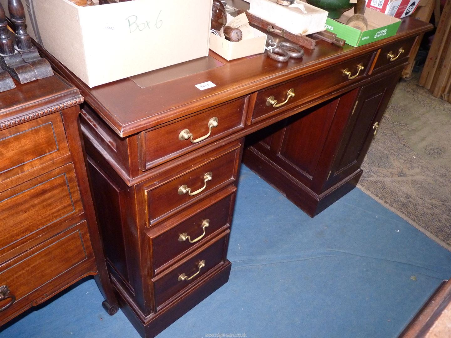 A Mahogany Kneehole Desk having three frieze drawers,