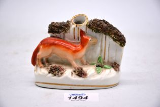 A 19th century Staffordshire fox spill vase having bocage decoration, 4" x 3 1/8" tall.