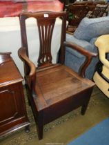 A peg-joyned Oak framed Georgian Commode Chair (unfurnished).