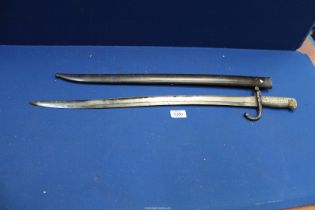 A brass handled Bayonet in sheath, number to hilt and sheath '63137', inscribed and dated 1868,