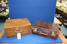 A dark brown leather vanity case having blue covered interior together with a tan brown vanity case
