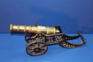 A cast iron and brass model cannon, 18 1/2" long x 8 1/4" high.