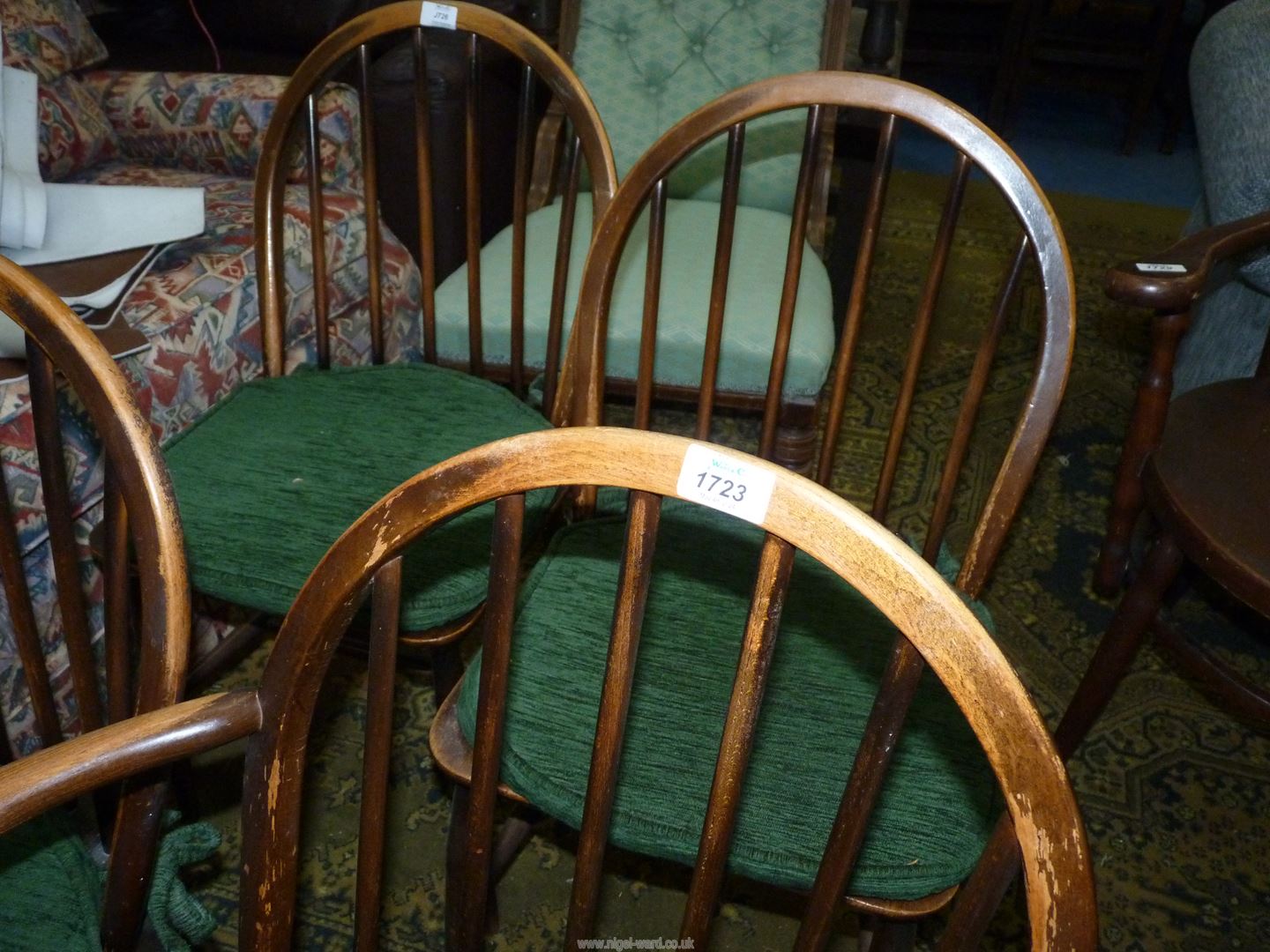 A set of four solid wood seated Ercol Dining Chairs having stick backs and green upholstered pad - Image 4 of 4