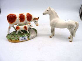 A Beswick 'Welsh Mare' (a/f) and a Staffordshire style Cow and calf.