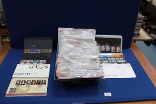 A large collection of First Day Covers in the original envelopes, stamps sets, etc.