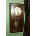 A Junghans Oak cased bevelled glazed two-train movement wall clock having Arabic numerals and