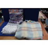 A 'Derw' Welsh Wool blanket in cream, blue and pink, a black and white diamond pattern throw,