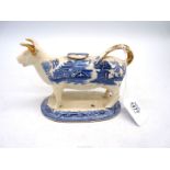 A blue and white willow pattern transfer printed cow creamer, circa 1830,