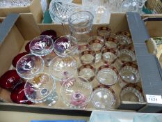 A quantity of glass including champagne bowls with coloured stems, lemonade set, ruby red glasses,